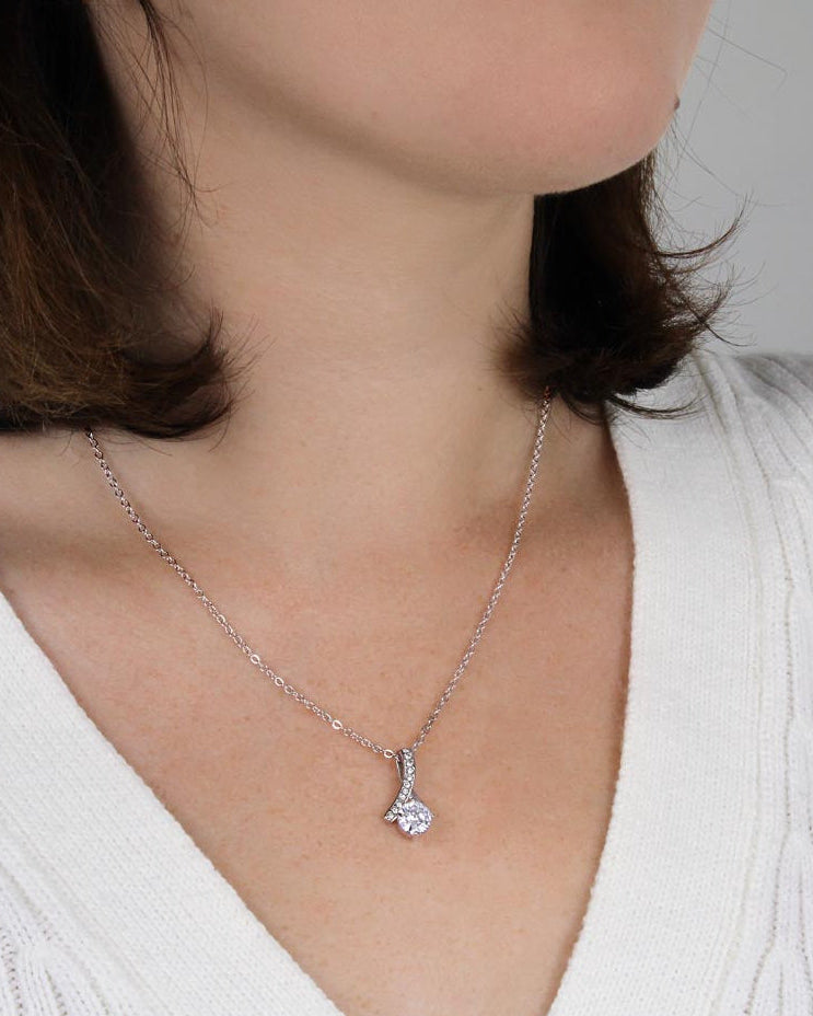 Woman wearing silver new mom pendant necklace